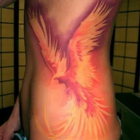 Татуировка у девушки на боку - жар-птица